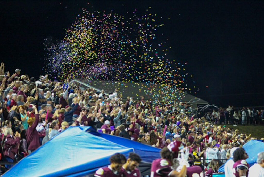 confetti flying in the air at a football game.