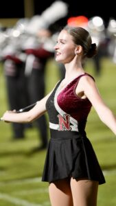 A Niceville high school baton twirler performs at halftime during the Niceville Crestview football game. This year, the band has developed an homage to the Eagles, classic rock band and play several of their hits.