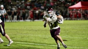 JON BOCCHINO thunders ahead on a sweep. The Niceville Eagles short yardage specialist proved useful throughout the night against the Bulldogs.