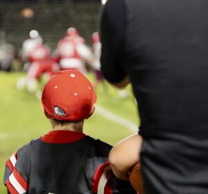 A future Crestview Bulldog watches play on the field develop between the Niceville Eagles and the Crestview Bulldogs.