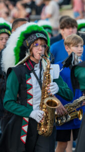 A Choctawhatchee high school saxophonist marches in the pregame parade to the field. The choctawhatchee style marcher band played the national anthem to open up the game between the Indians and the Eagles.