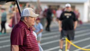 A Niceville high school assistant coach looks onto the field as Eagles warm up before the game between Niceville high school and Choctawhatchee high school in Fort Walton Beach.