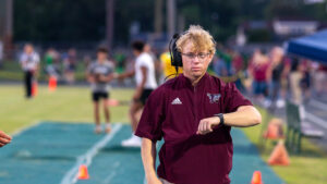 A Niceville high school assistant coach checks his watch immediately before kickoff in the game between Niceville high school and choctawhatchee high school.