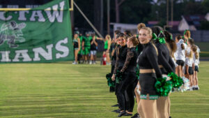 Choctawhatchee high school dance team members and cheerleaders wait for the Choctaw Indians to run through their banner before the high school football game between Choctawhatchee high school and Niceville high school