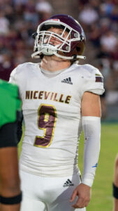 Harper Campbell looks up at a coin as it flies through the air. Niceville high school would win the coin toss, and defer to receive the football in the second half.