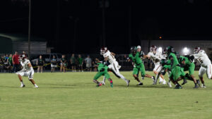 JJ Lewis of Niceville high school puts out a hand to Ward off Amir Reese of Choctaw high school as he runs down the field. Lewis has a total of 312 yards on the ground so far this year.
