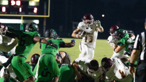 Jon Bocchino hurdles through the air into the end zone for a touchdown against Choctawhatchee high school. Bocchino has a team leading seven touchdowns on the year – and is typically used in short yardage situations for the Eagles.