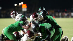 Jon Bocchino holds fast to the football as he throws his body into a horde of Choctawhatchee Indians. The Referees would credit Bocchino with his seventh touchdown of the season.
