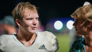 A Niceville High School Football Player talks with a fellow student after the 42-25 win over Choctawhatchee High School