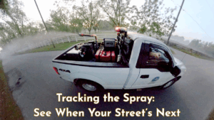 Mosquito control truck spraying mist along a residential road in Okaloosa County at dusk.