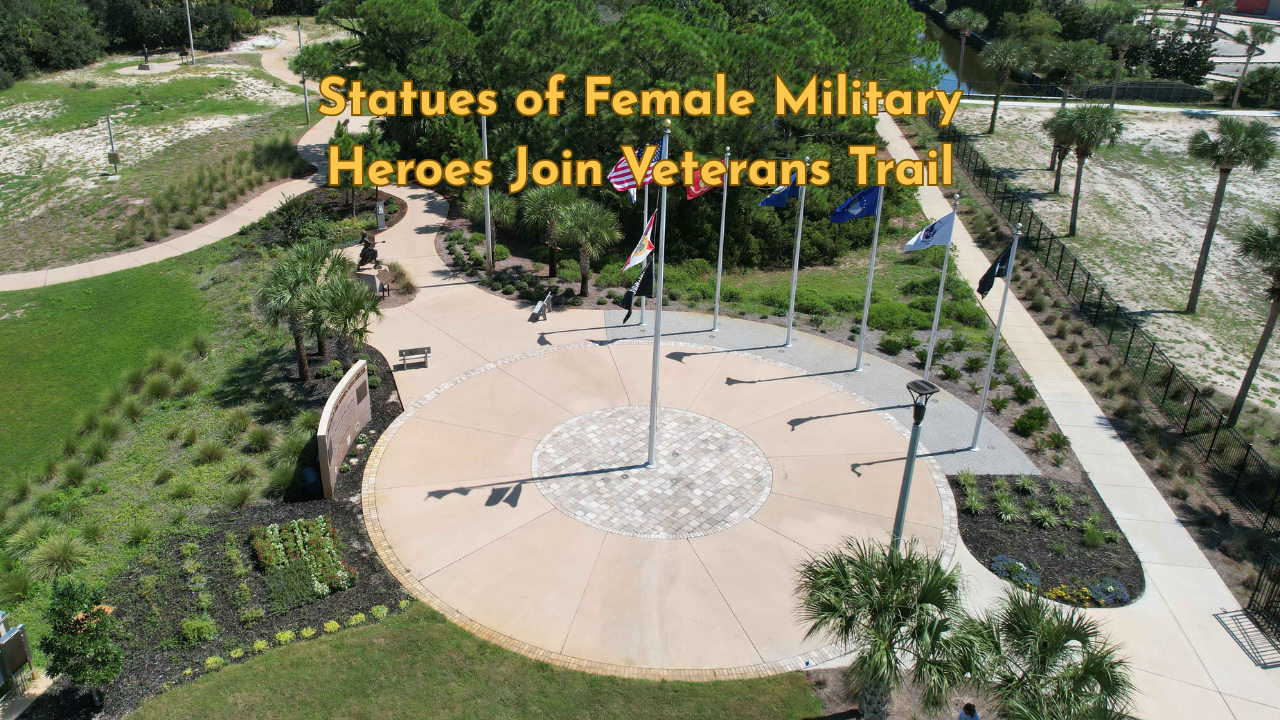 Aerial view of Veterans Park on Okaloosa Island, featuring flagpoles, winding pathways, and surrounding greenery near the shoreline.