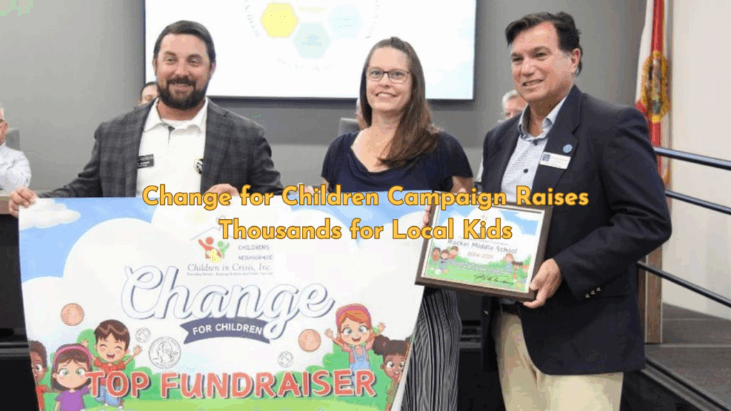 Superintendent presents award to Ruckel Middle School staff for raising the most money in Okaloosa’s Change for Children Campaign, with banner and plaque visible.