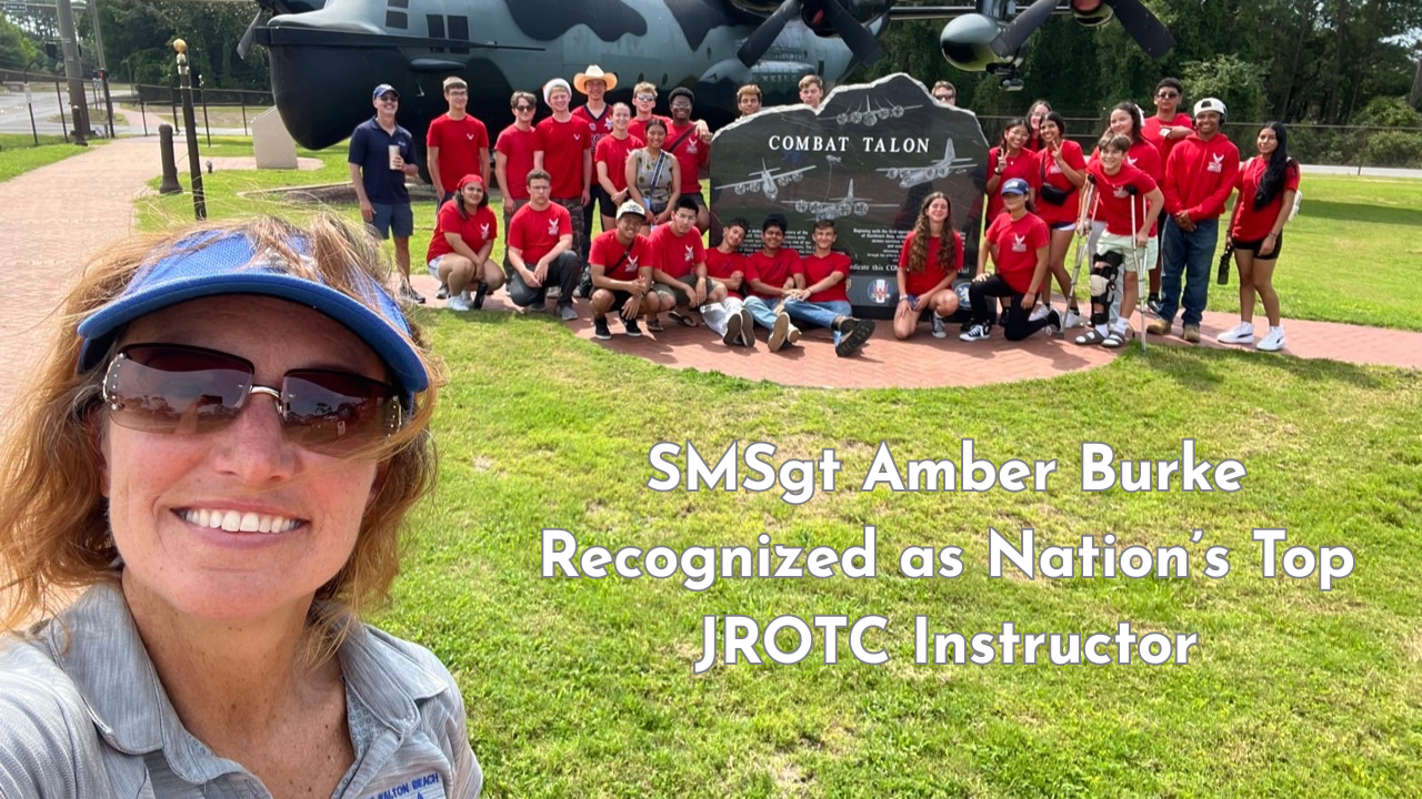 SMSgt Amber Burke takes a selfie with Fort Walton Beach High School AFJROTC cadets in front of the Combat Talon memorial aircraft.
