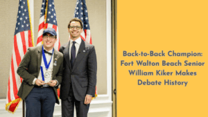William Kiker stands with Incubate Debate Founder James Fishback after winning his second national championship, holding a trophy in front of American flags.