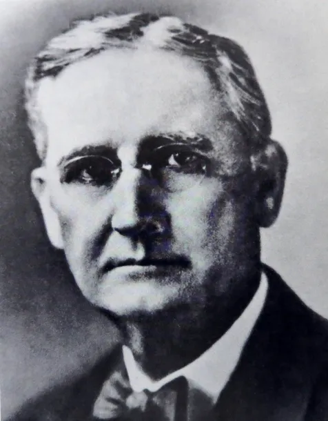 a man with glasses and a bowtie.
