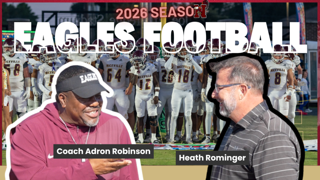 Coach Adron Robinson and Heath Rominger chat before a Niceville Eagles football team, with bold 'EAGLES FOOTBALL' text behind them and a 2026 season banner