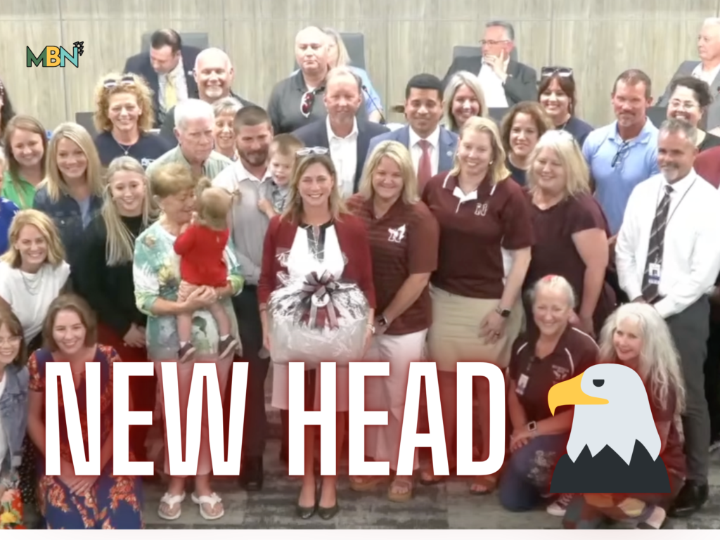 Group of adults smiling for a group photo at an event, with the MBN logo in the top-left and a large red text overlay at the bottom.