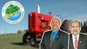Walton County, Florida preservation and conservation seal on left, with a red tractor and two men in suits in the foreground.