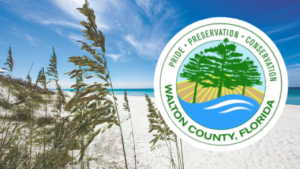 Sunny beach with white sand and sea oats; blue ocean on the horizon, and a Walton County, Florida seal overlaid on the right.