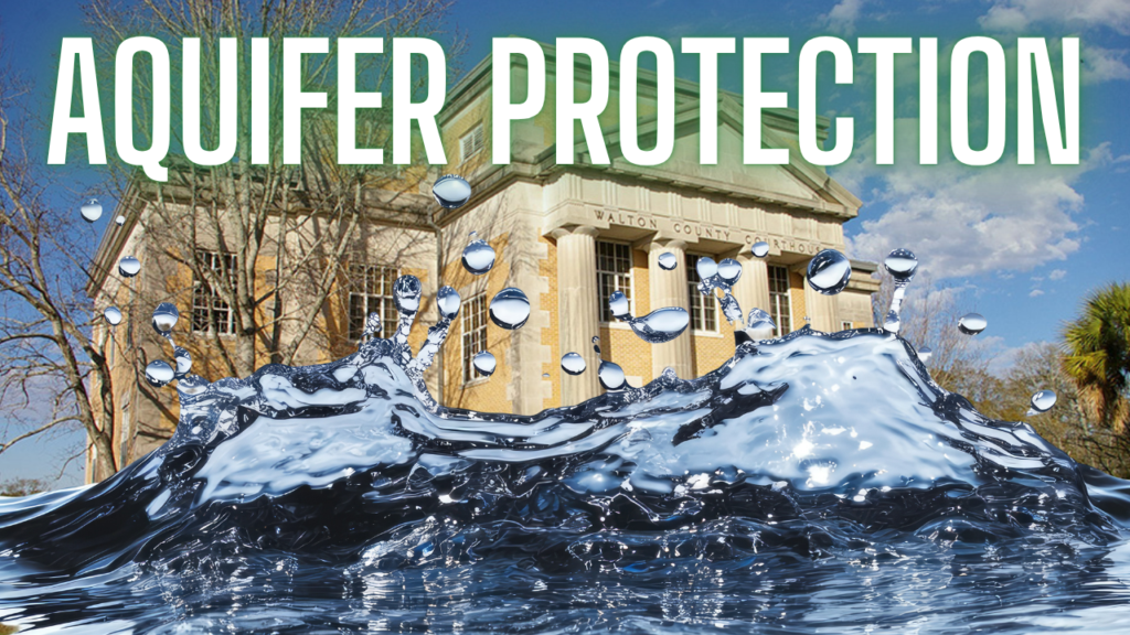 Courthouse with a large water splash in the foreground and the headline 'AQUIFER PROTECTION' across the top