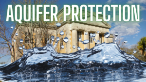 Courthouse with a large water splash in the foreground and the headline 'AQUIFER PROTECTION' across the top