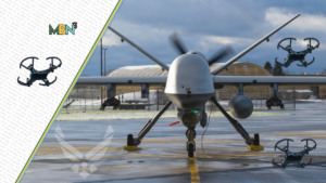 Front view of a large quadcopter drone on a runways tarmac with spinning propellers, flanked by smaller drone overlays and MBN branding on the left banner.