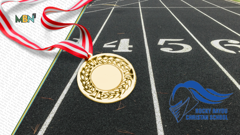 Gold medal with a red-and-white ribbon lies on a dark running track beside lane numbers, with MBN and Rocky Bayou Christian School logos visible.
