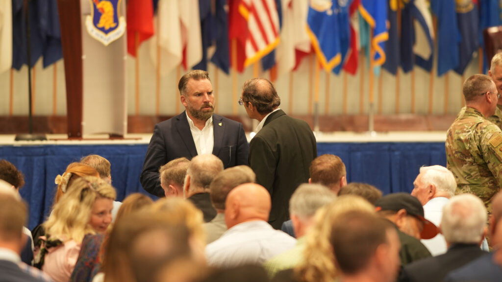 Shalimar Mayor Mark Franks and Crestview Mayor JB Witten speak before the change of command ceremony at Eglin Air Force Base.