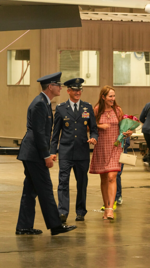 Colonel Chris Keithley walks with his wife to a portrait area in front of an F-15 EX after his change of command ceremony. Keithley took over the 96th Test Wing on June 16, 2026.