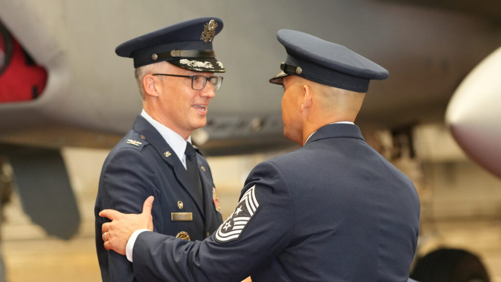 A command chief master sergeant congratulates Colonel Chris Keithley on his change of command ceremony at Eglin Air Force Base on June 16, 2026. Keithley took over the position for Brigadier General Mark Massaro, who will head to Edwards Air Force Base in California.