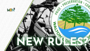 Bicycles with a bold 'NEW RULES?' overlay and an environmental seal on the right side, suggesting a rule or policy topic about bikes and conservation.