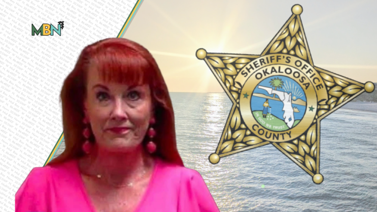 Woman in a bright pink blouse stands before a large Okaloosa County Sheriff's badge over a sunlit ocean scene, with a patterned left panel and MBN logo.